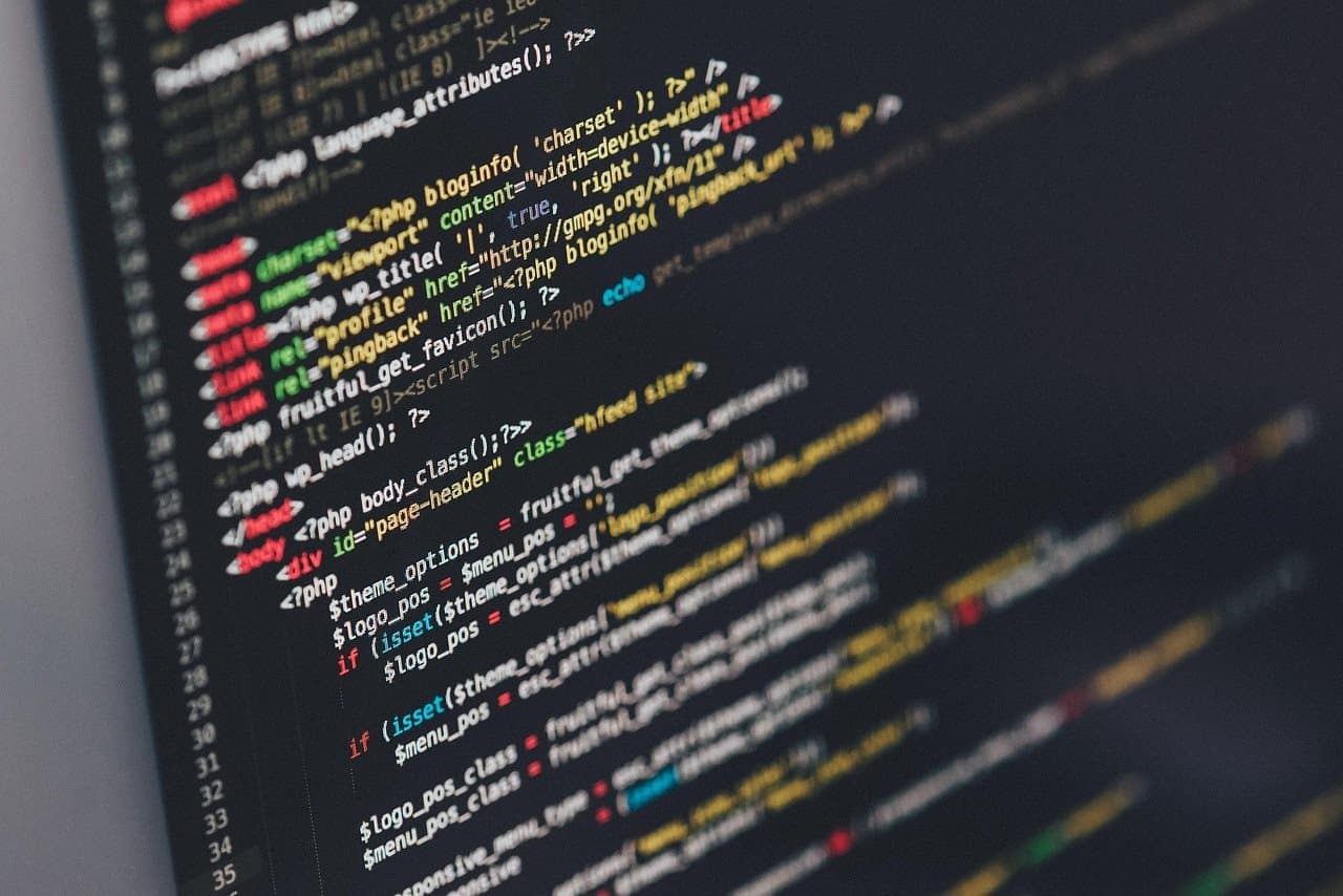 Close-up of colorful source code on a dark screen